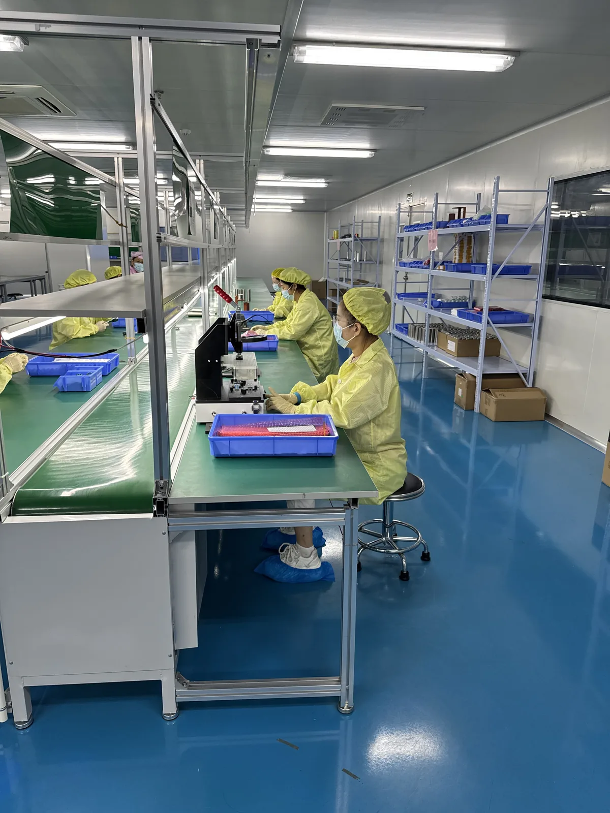 Assembly station on the production line with component trays and fixtures laid out at the bench