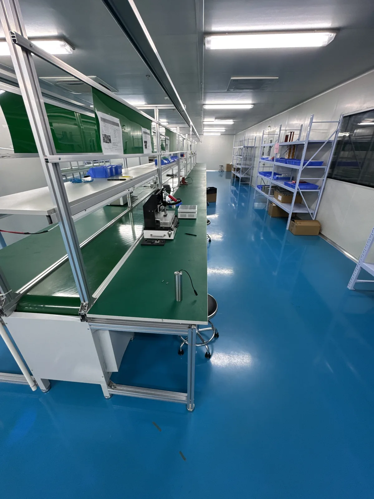Production corridor with coated flooring and stainless-steel workstations beyond