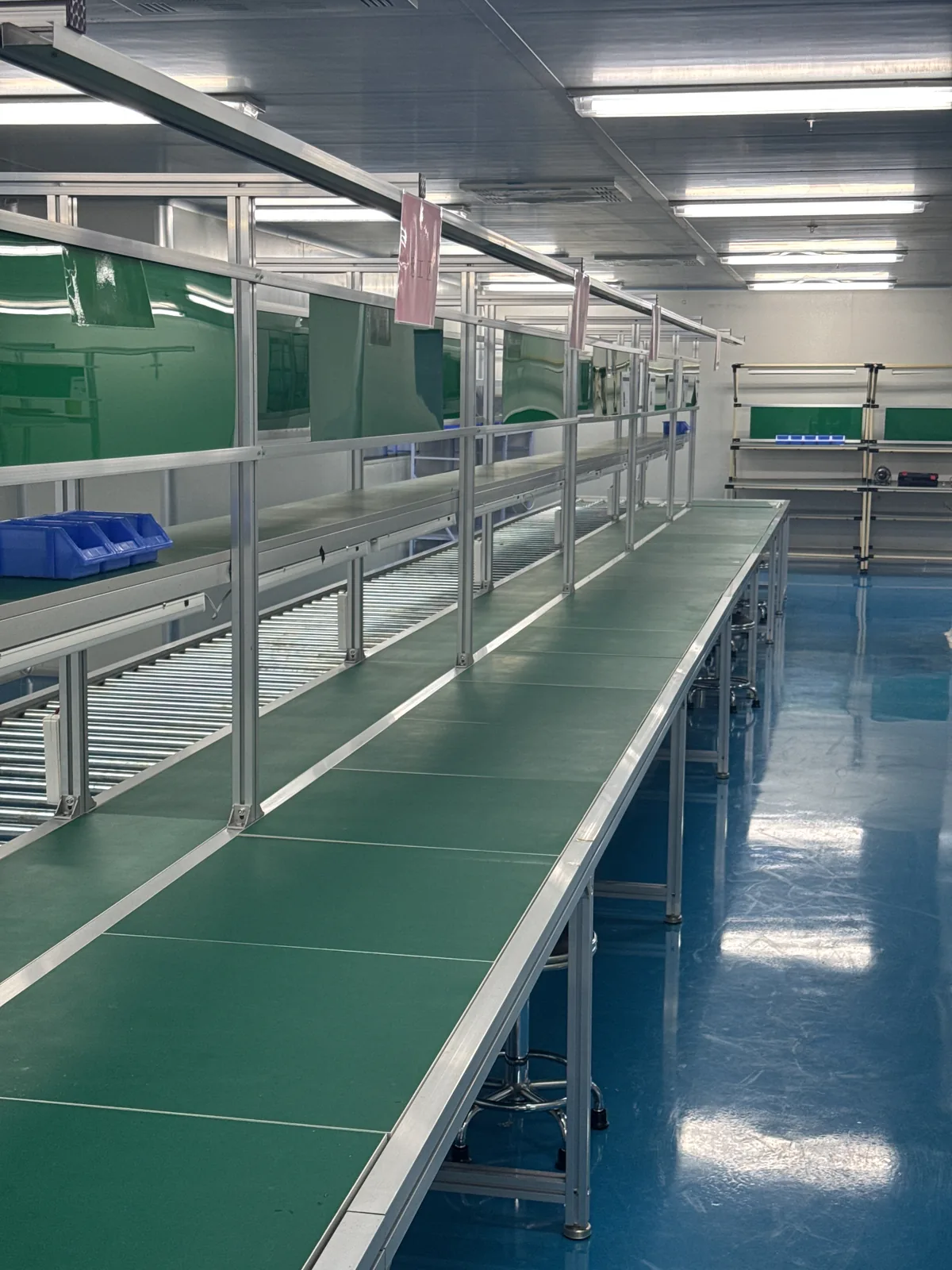 Cleanroom corridor running through the controlled production area to stainless-steel workstations
